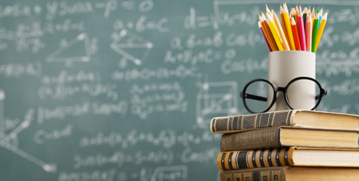 blackboard, books, glasses, and colored pencils